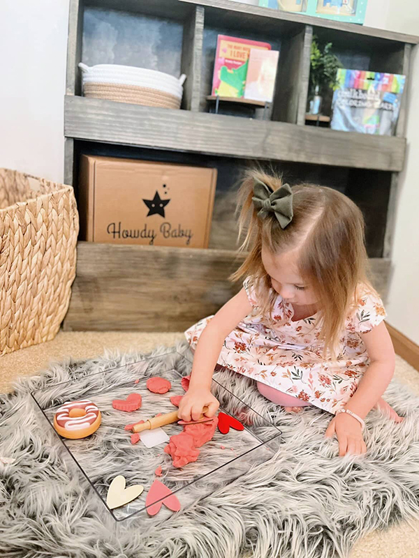 little girl playing with sensory play dough