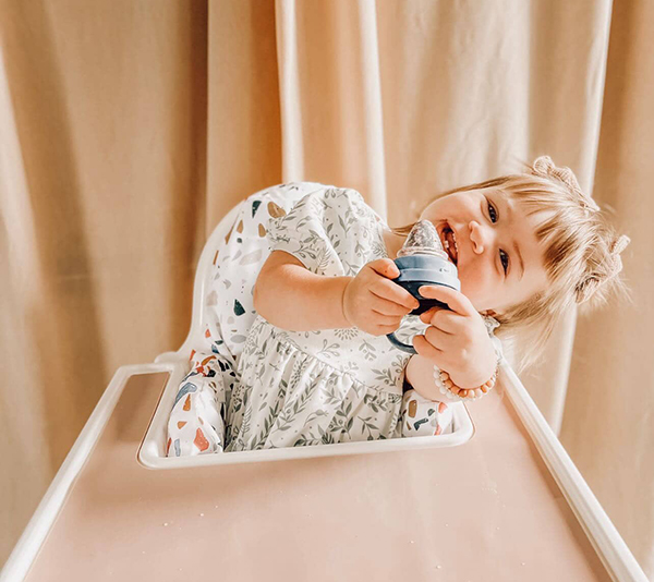 toddler engaging in sensory play with food