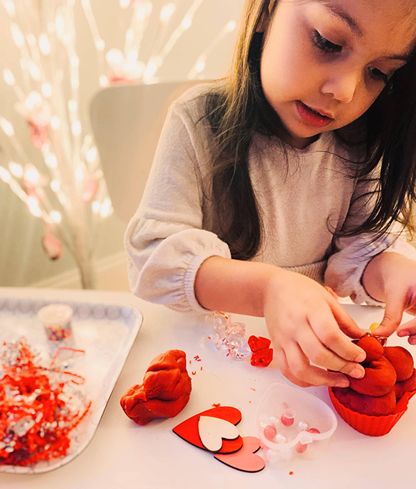 preschool aged girl playing with sensory playdough kits