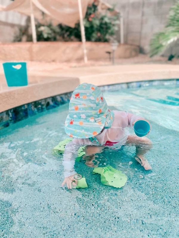 toddler taking part in sensory water play activities