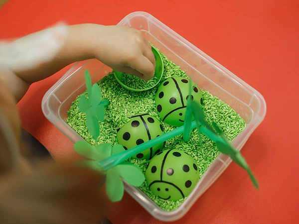 spring ladybug themed sensory bin for toddlers and preschool aged kids