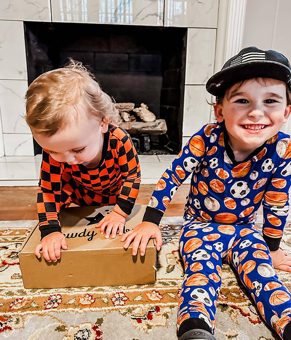 kids opening their July 2023 Howdy Baby subscription box for girls and boys