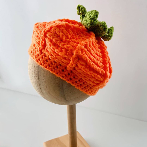 side view of the orange knit pumpkin hat from the October 2023 Howdy Baby subscription box