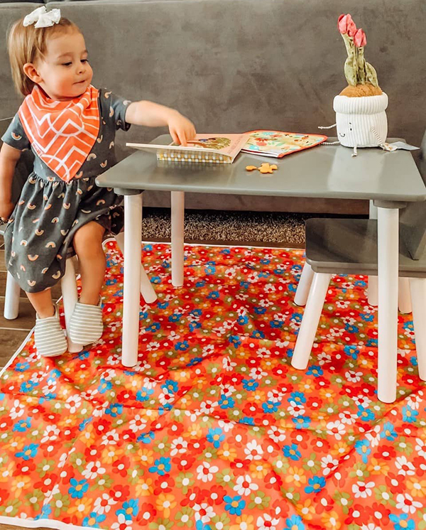 toddler girl unboxing her Howdy Baby subscription box for May 2022