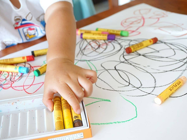 toddler coloring with crayons