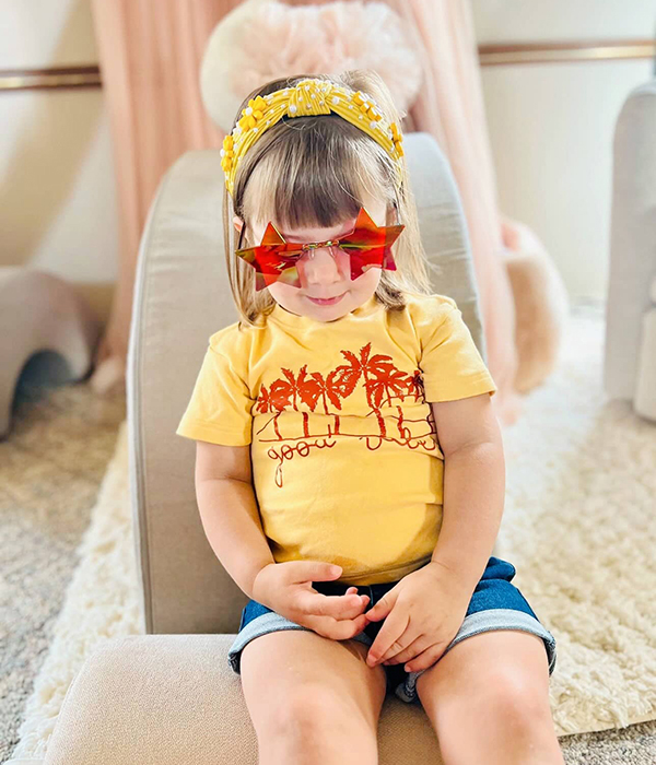 toddler girl wearing star shaped rock star sunglasses