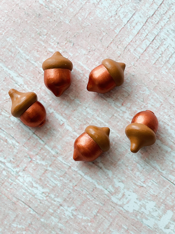 hand painted wooden acorns for loose part sensory tray play