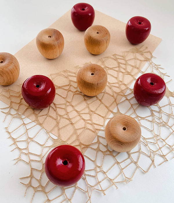 red and natural colored wooden apples for kids open ended play