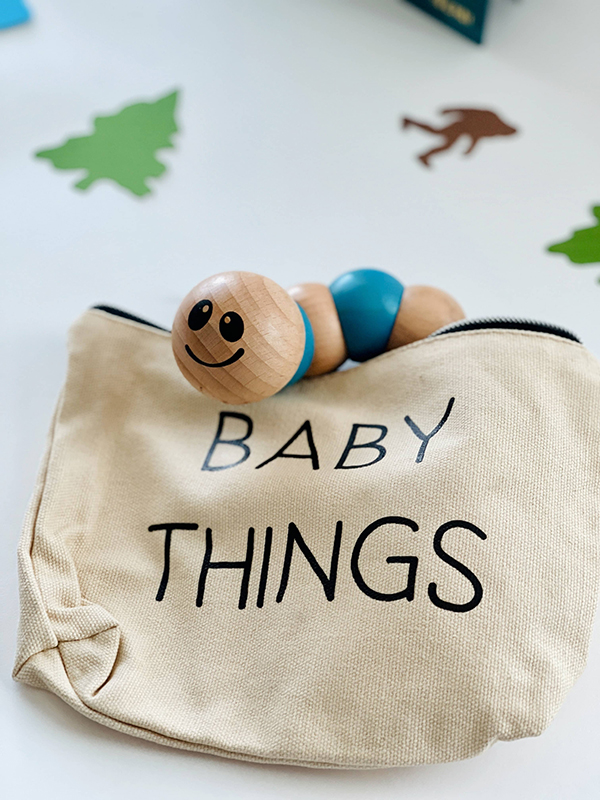 wooden worm clutching toy with a baby things zippered travel tote