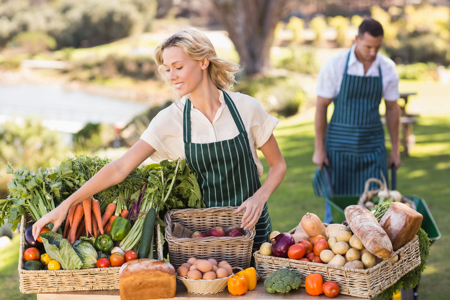 148-farmer-web-woman-tidying-up-a-table-of-local-food-at-pvy7ehd.jpg