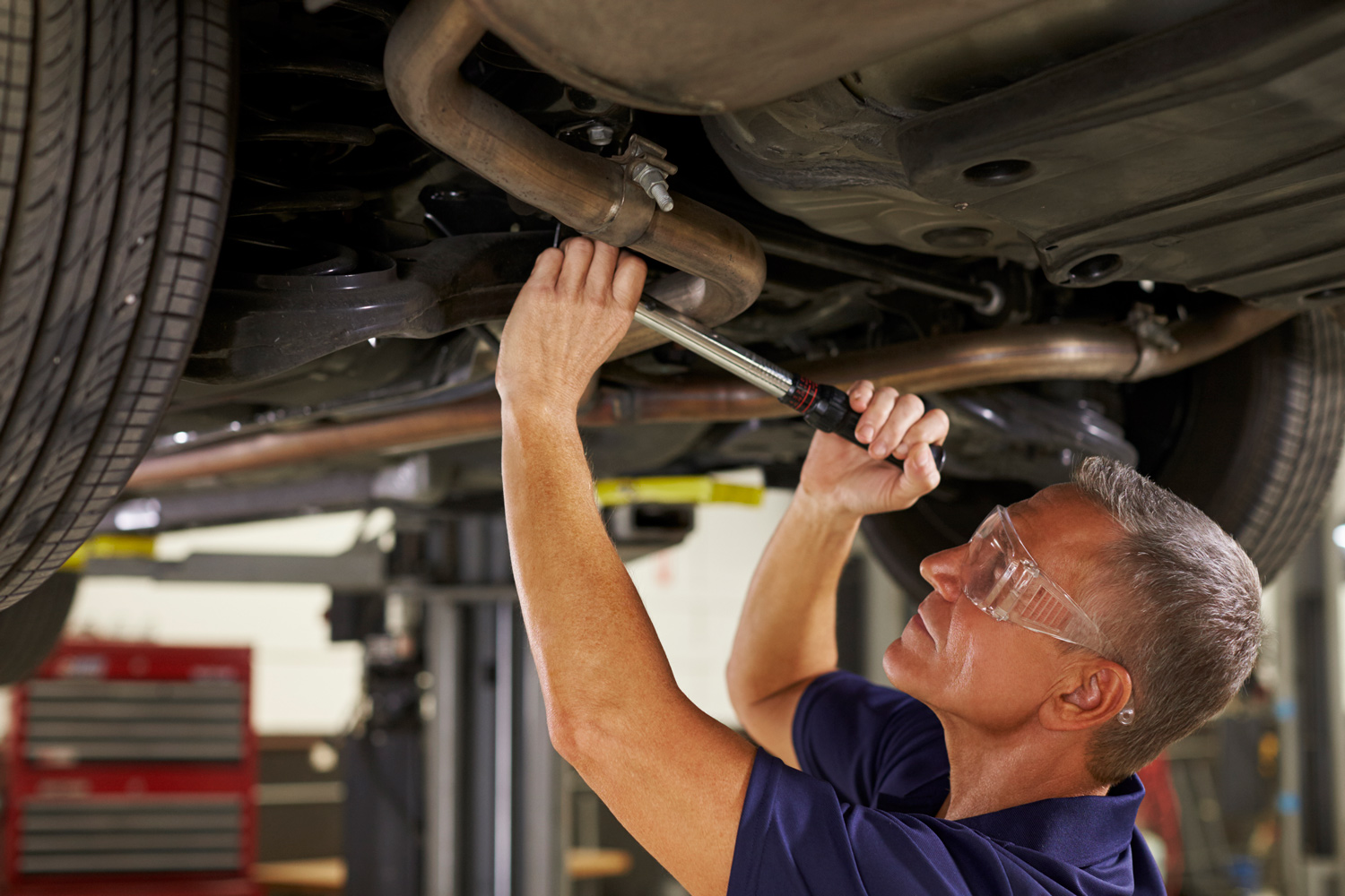 203-auto-mechanic-web-working-underneath-car-in-garage-p8a59na.jpg