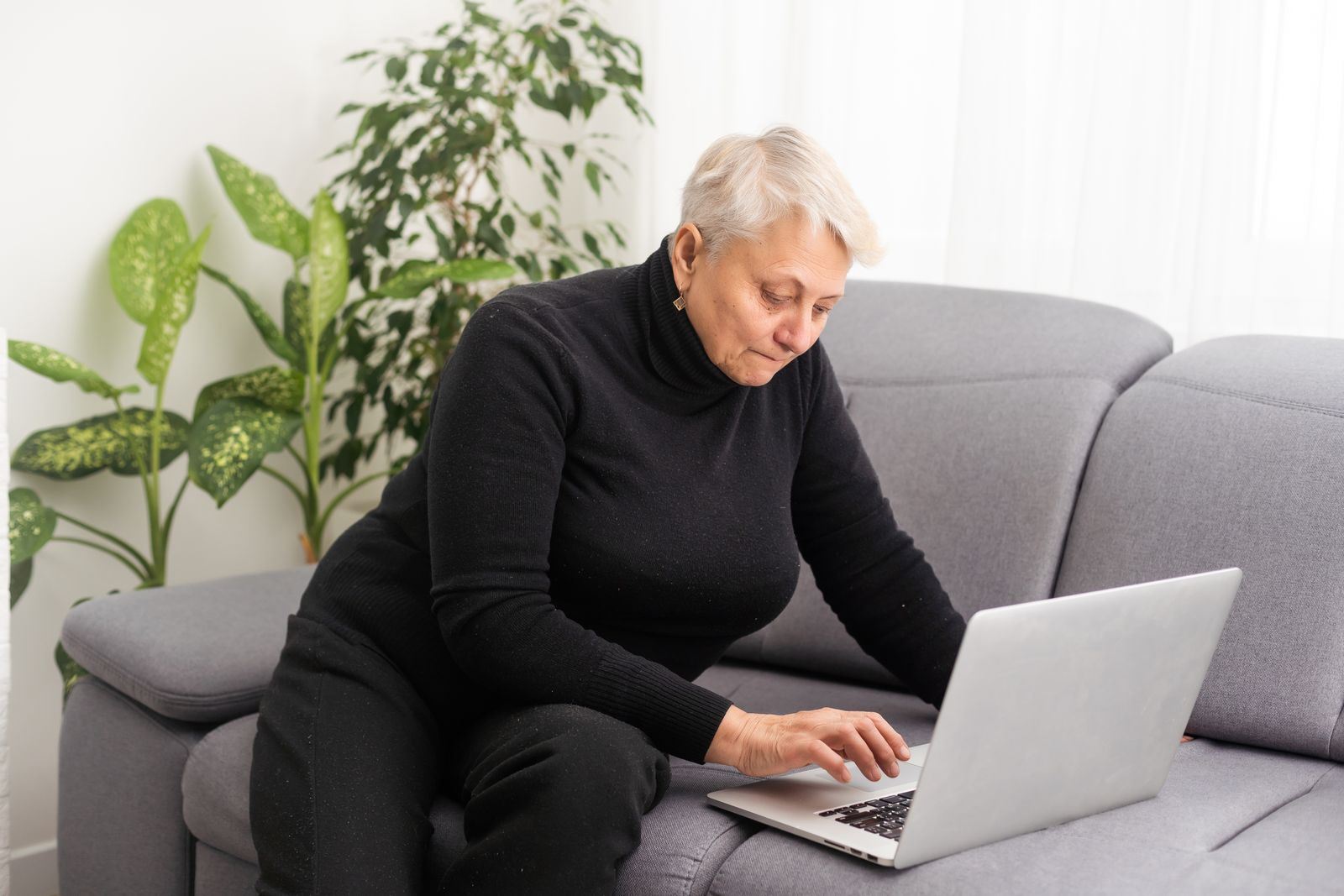 618-50394892front-view-concentrated-pleasant-mature-older-woman-looking-at-computer-16813086727466.jpg
