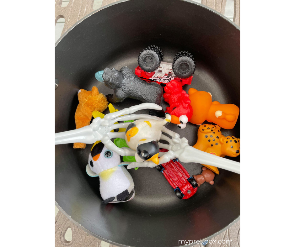 Preschool Halloween Literacy Activity, pot with small toys