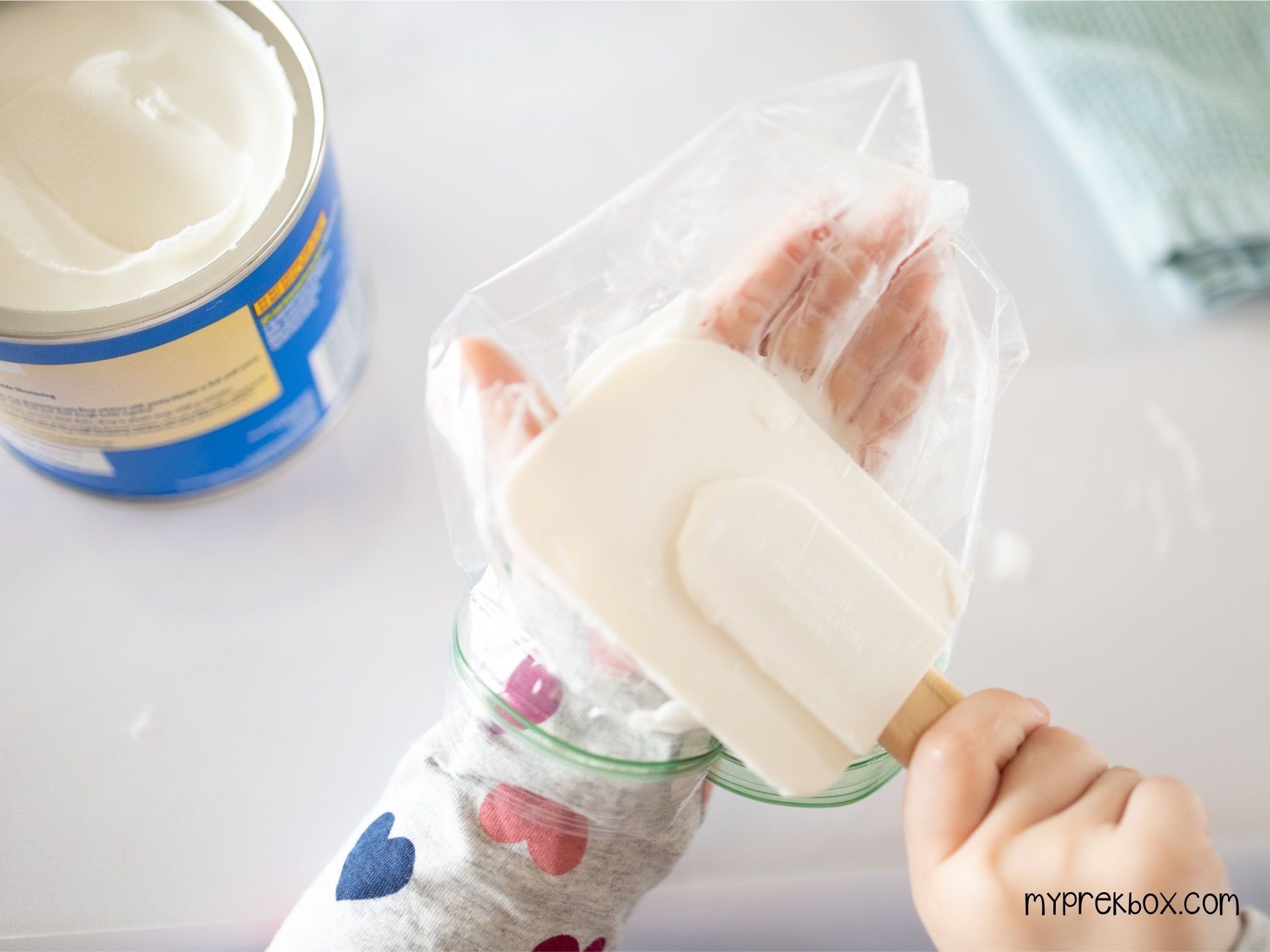 child putting crisco on hand