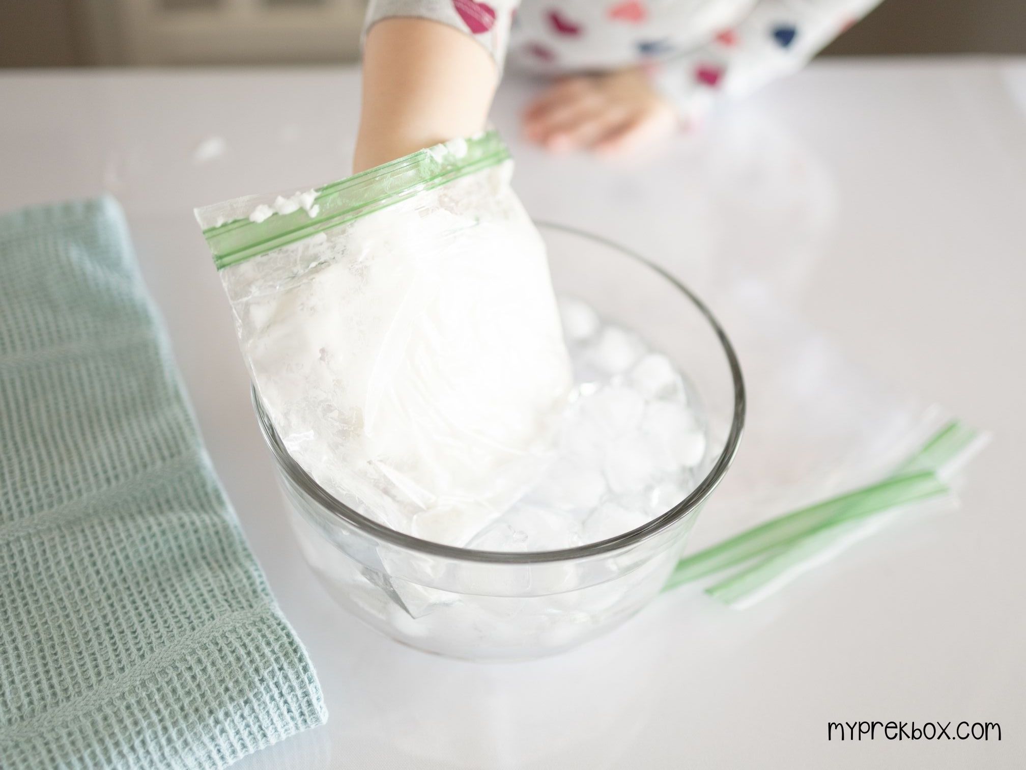 child putting crisco hand in ice water