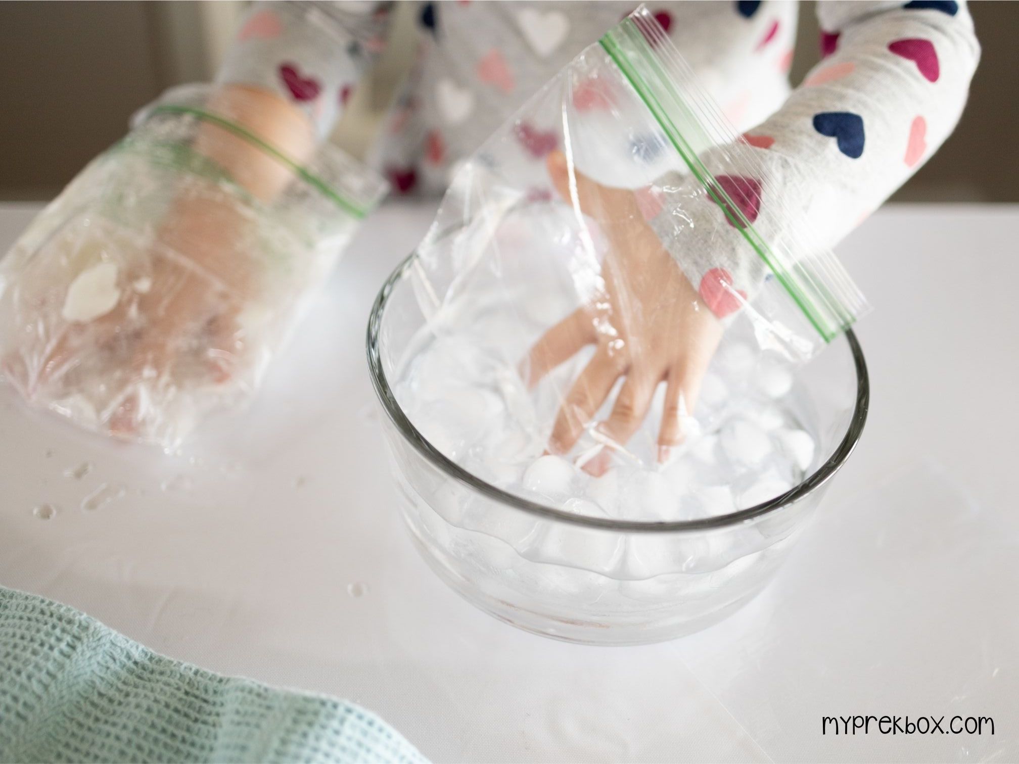 girls hand in plastic bag in ice water
