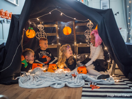 kids on a Halloween-themed tent