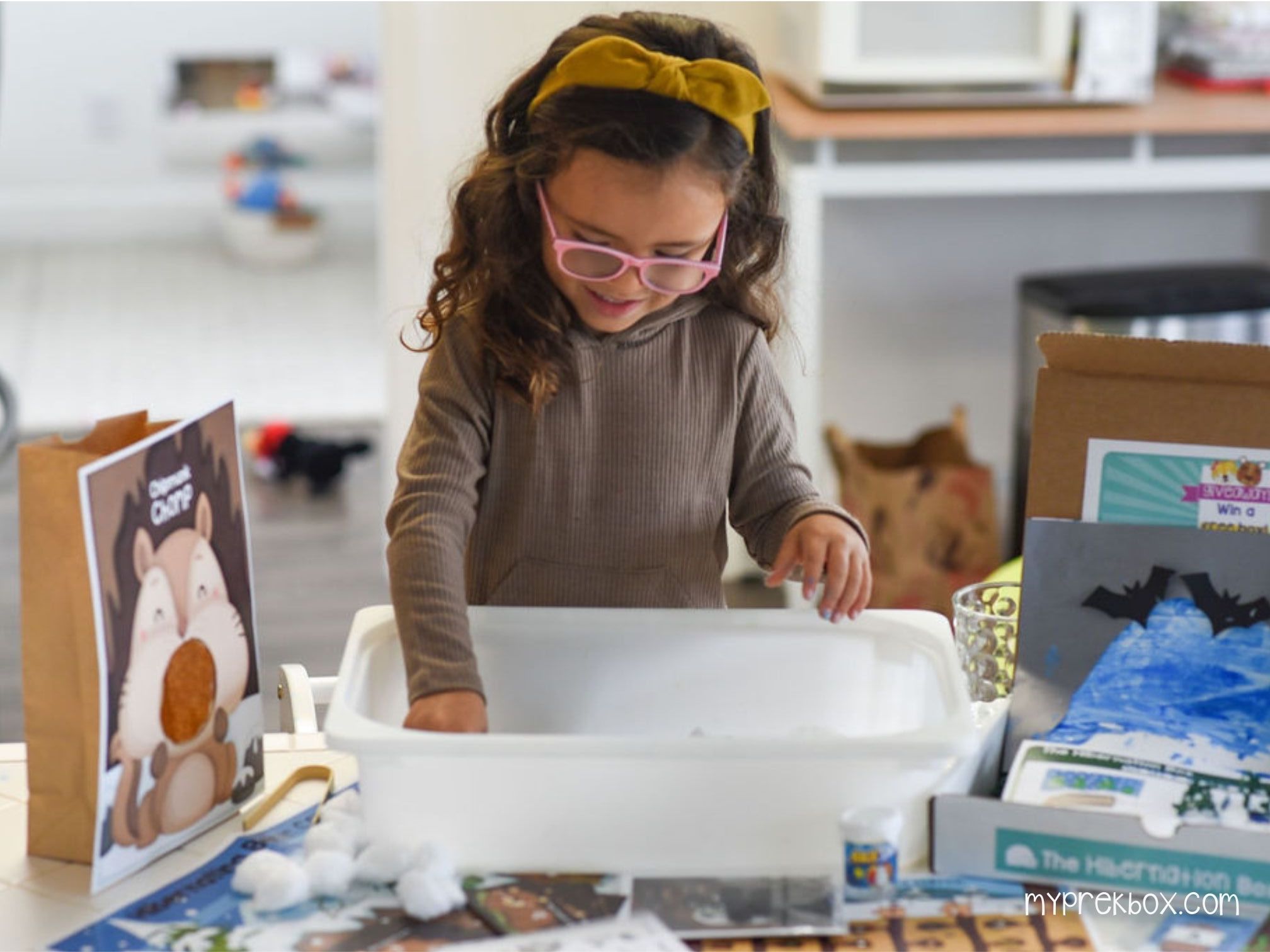 hibernation box girl playing with sensory snow