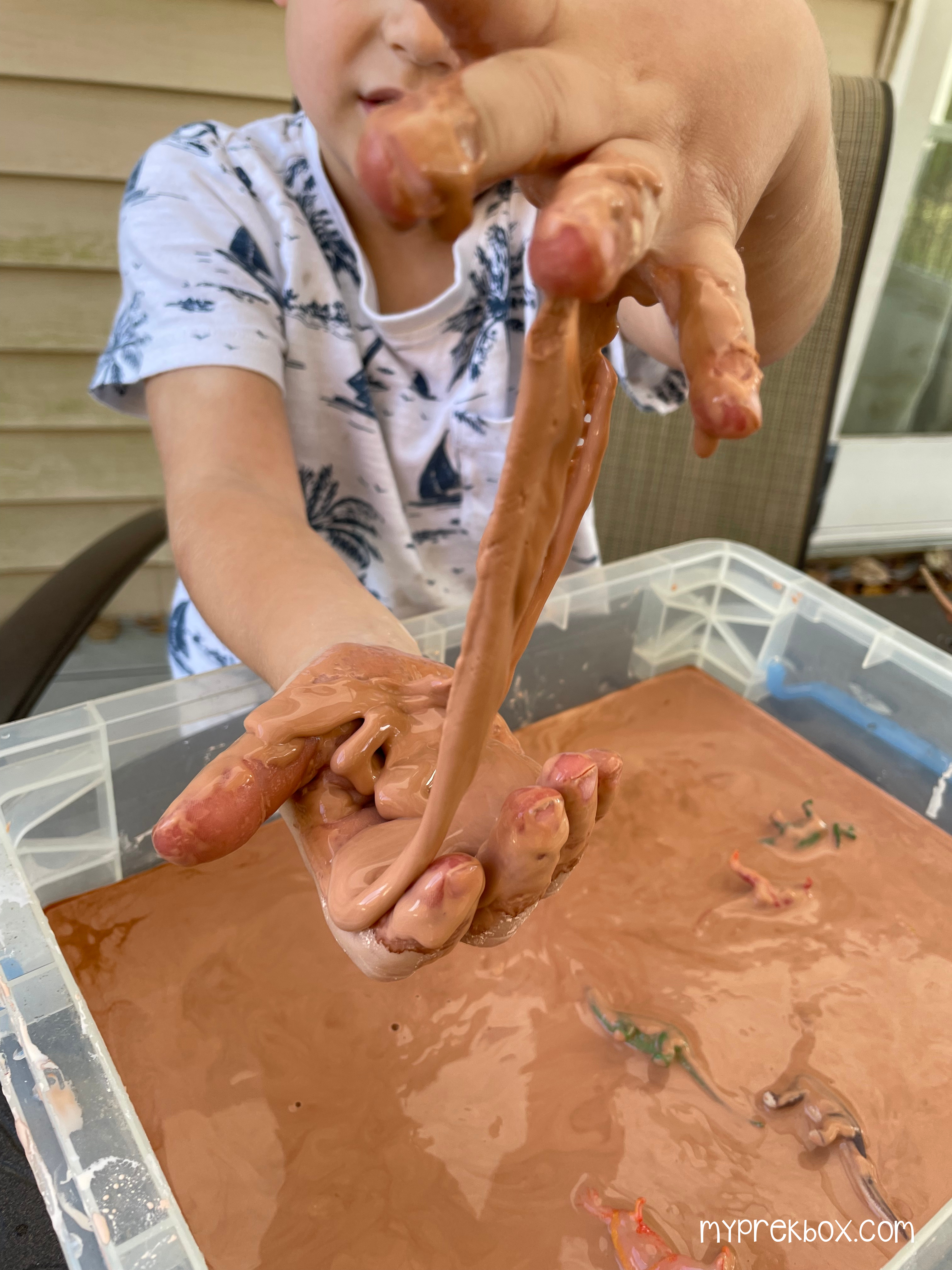 kid pulling apart quicksand mixture
