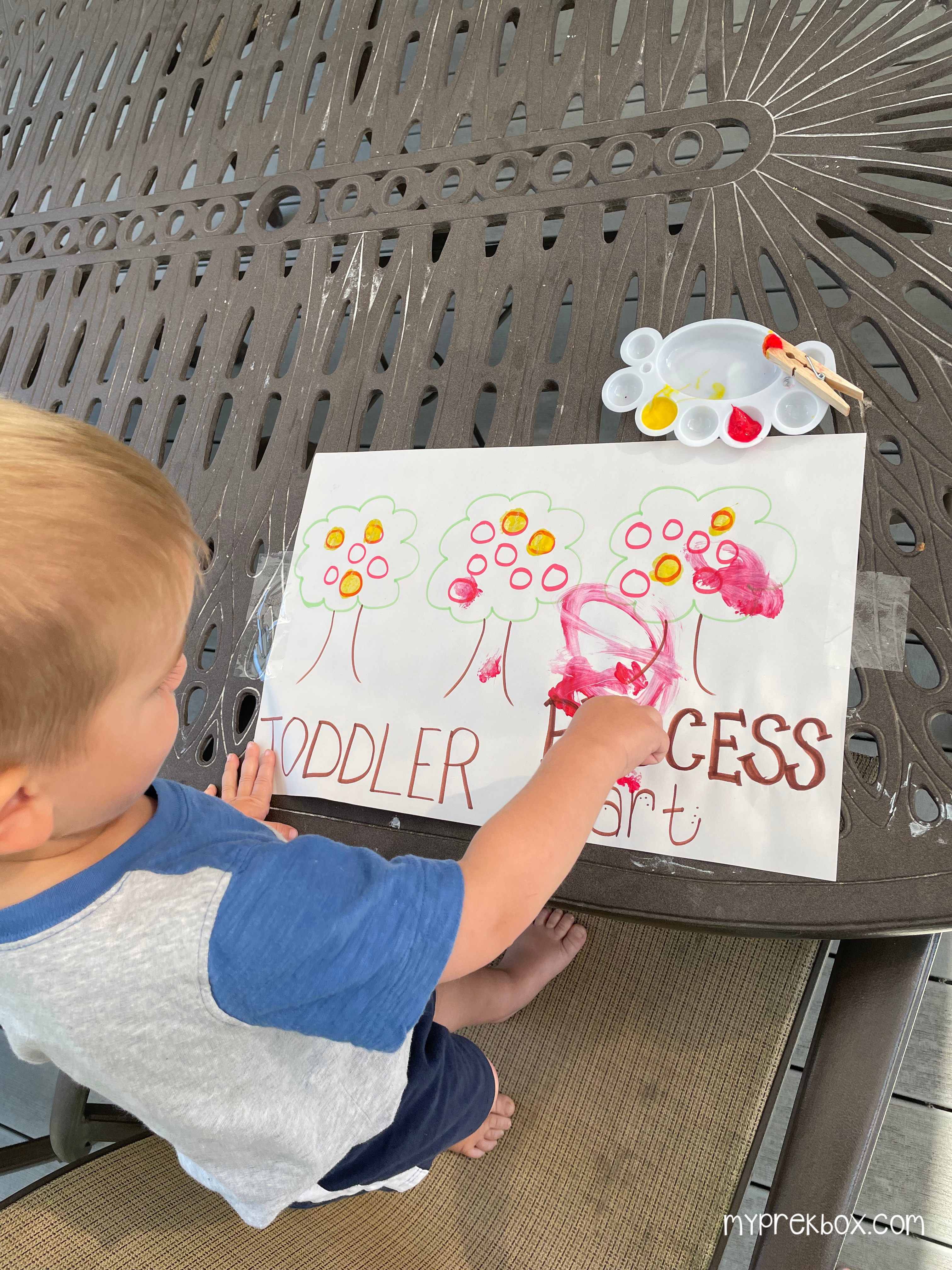 child doing level 1 paint by number pom pom apple painting