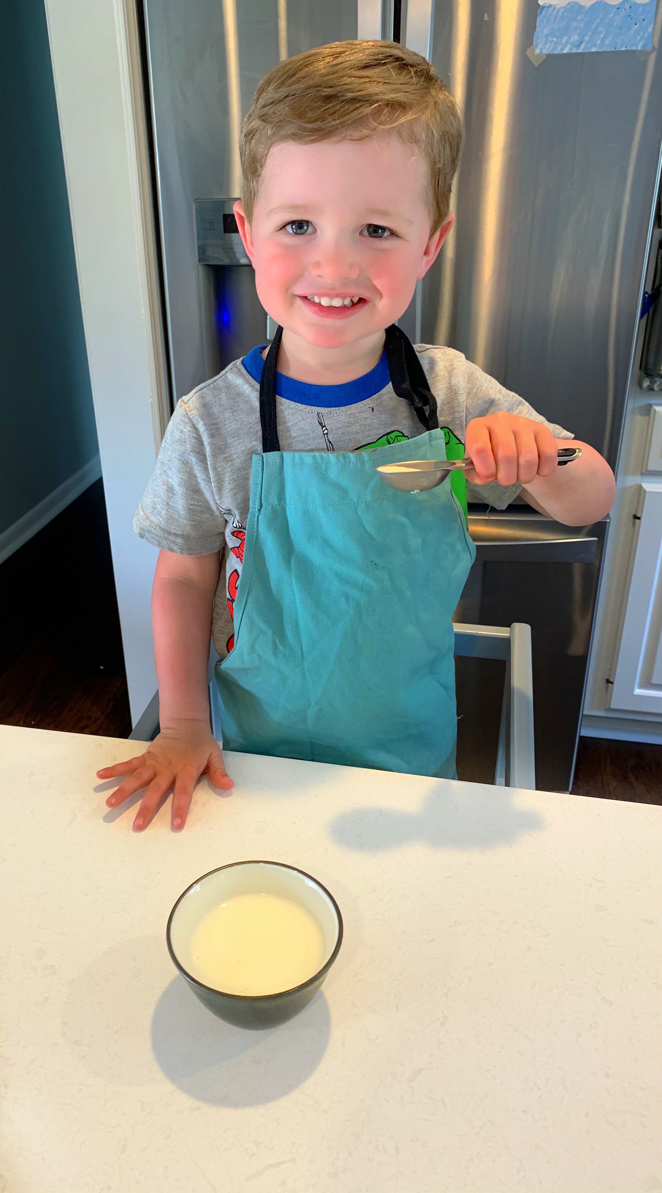 Young child with sugar for My Pre-K Box's Ice Cream in a Bag Science Experiment for Preschoolers and Little Kids