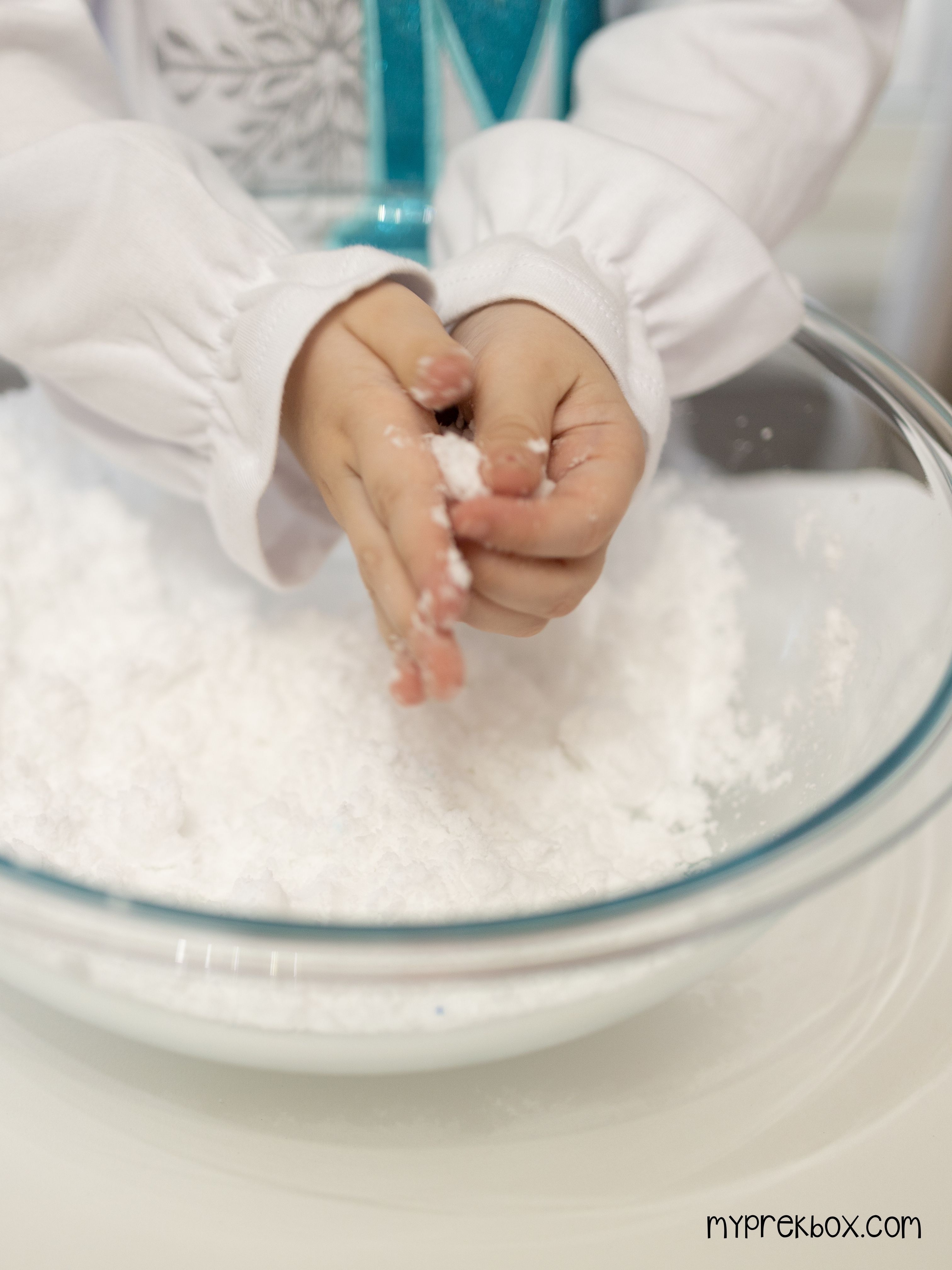 preschooler playing with sensory snow