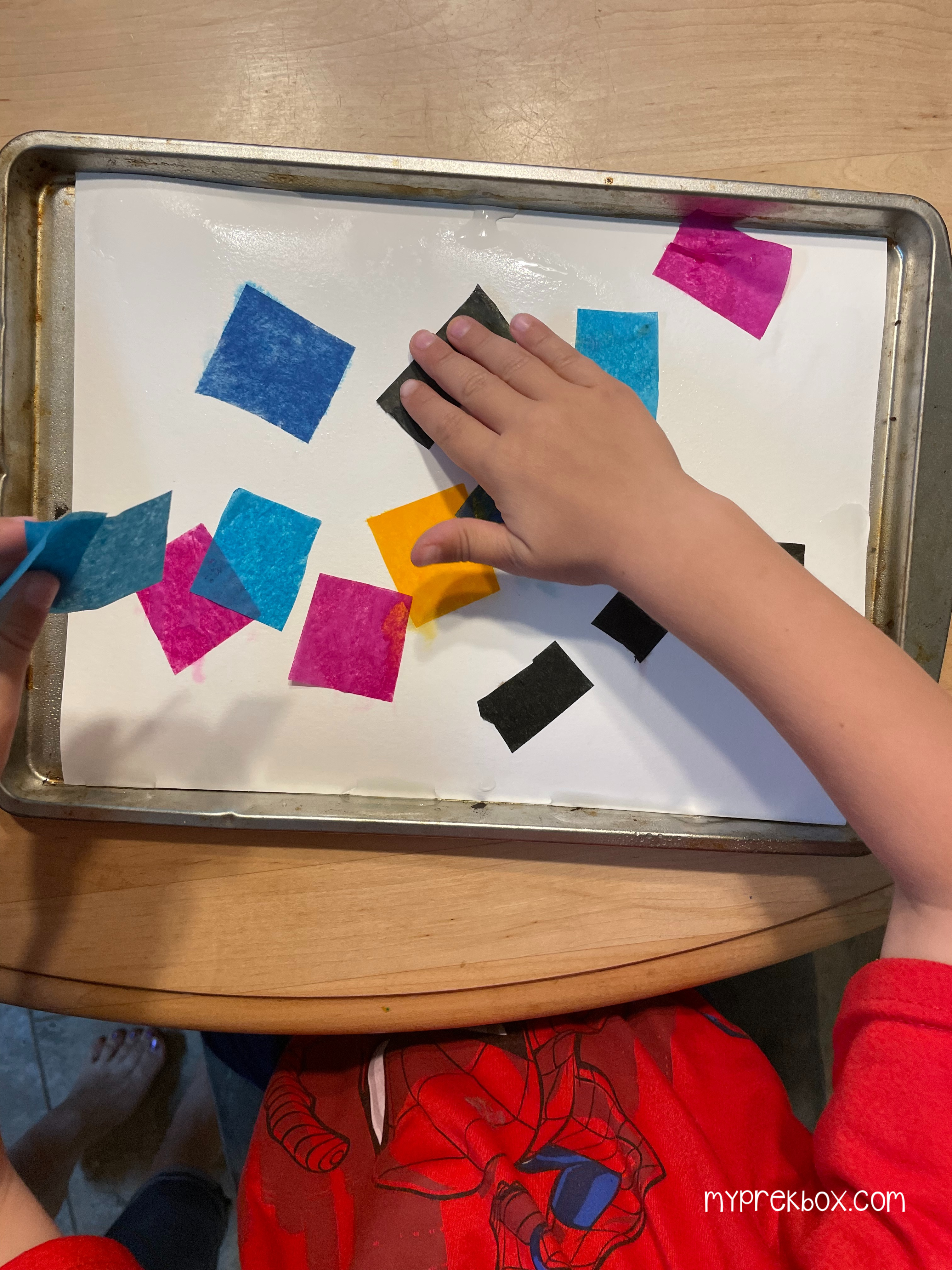 spooky silhouettes, kid laying down tissue paper on white paper