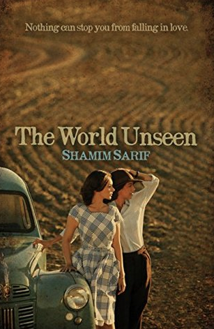 Cover of The World Unseen. Two women stand by an old car, one in a dress, the other dressed masculine. Both lookng the same direction, possibly at the sunset.