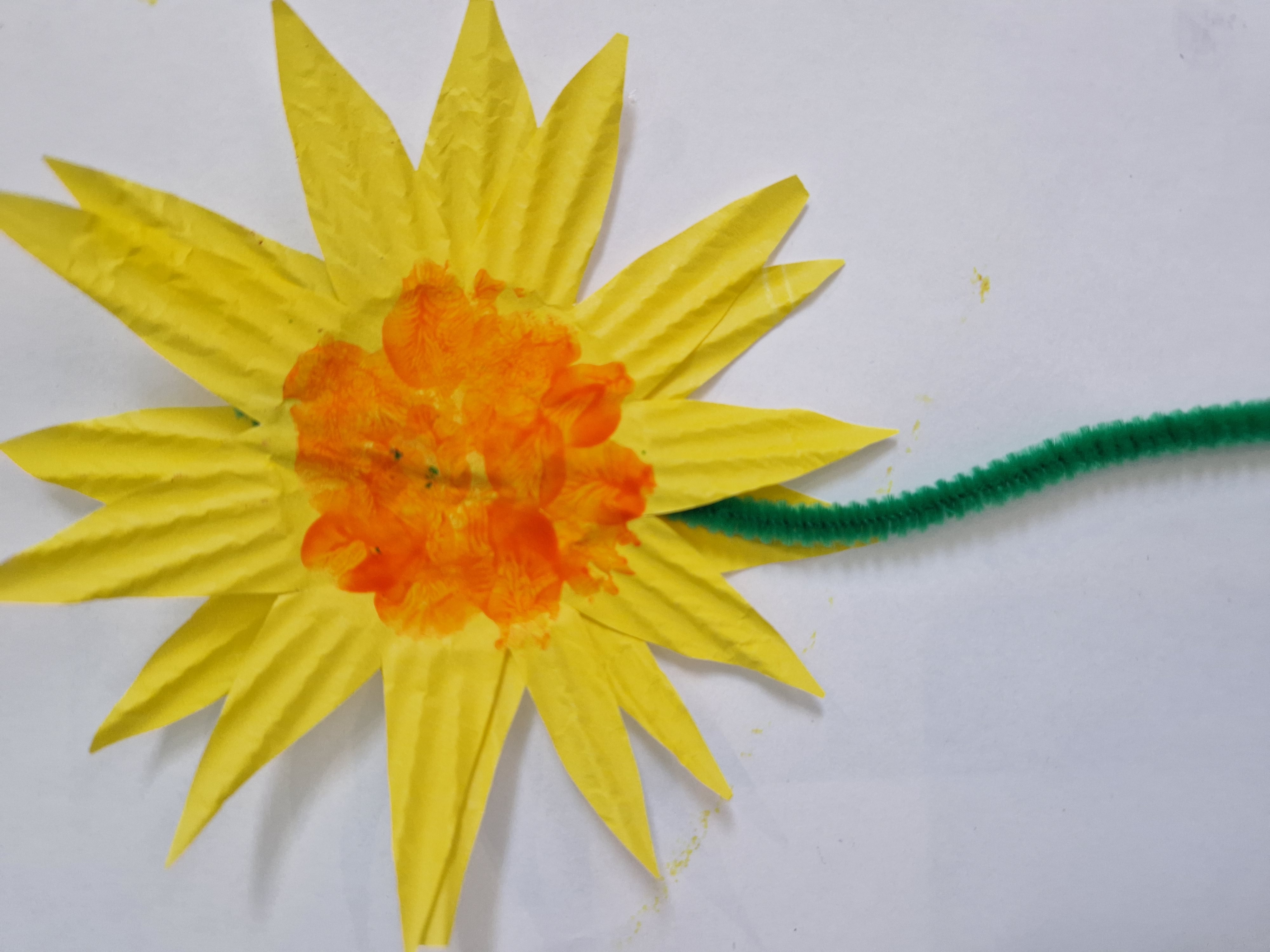 Sunflowers using yellow cupcake cases and green pipe cleaners