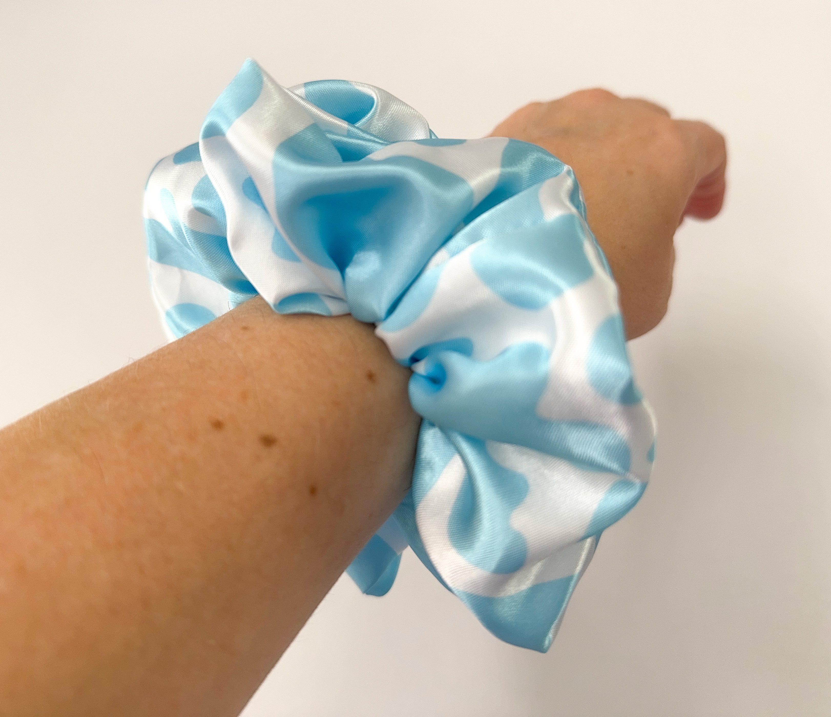 334-scrunchie-light-blue-cow-print-on-wrist-17540655473791.jpg