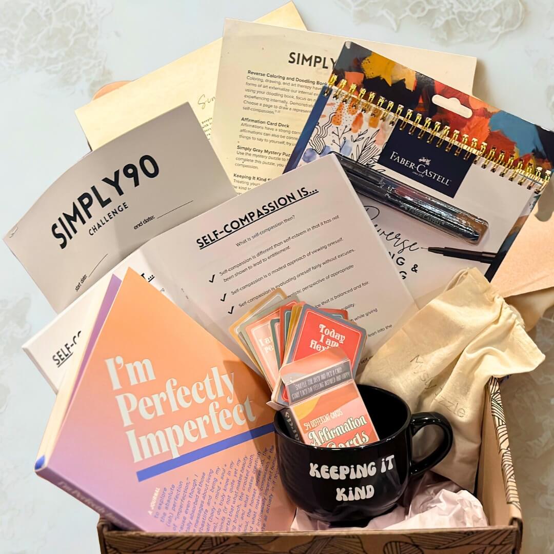 Self-Compassion mental wellness box with journal, affirmation cards, workbook, art tools, and mug from Simply Gray.