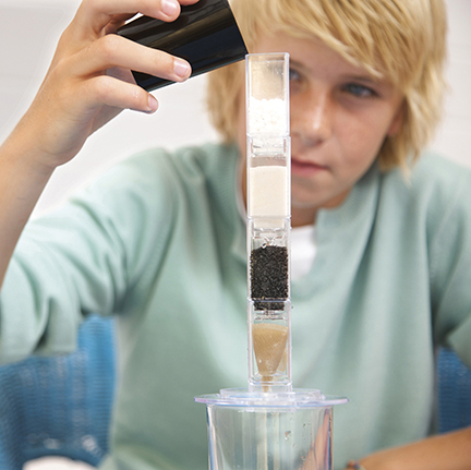 Boy making a water filtration science project