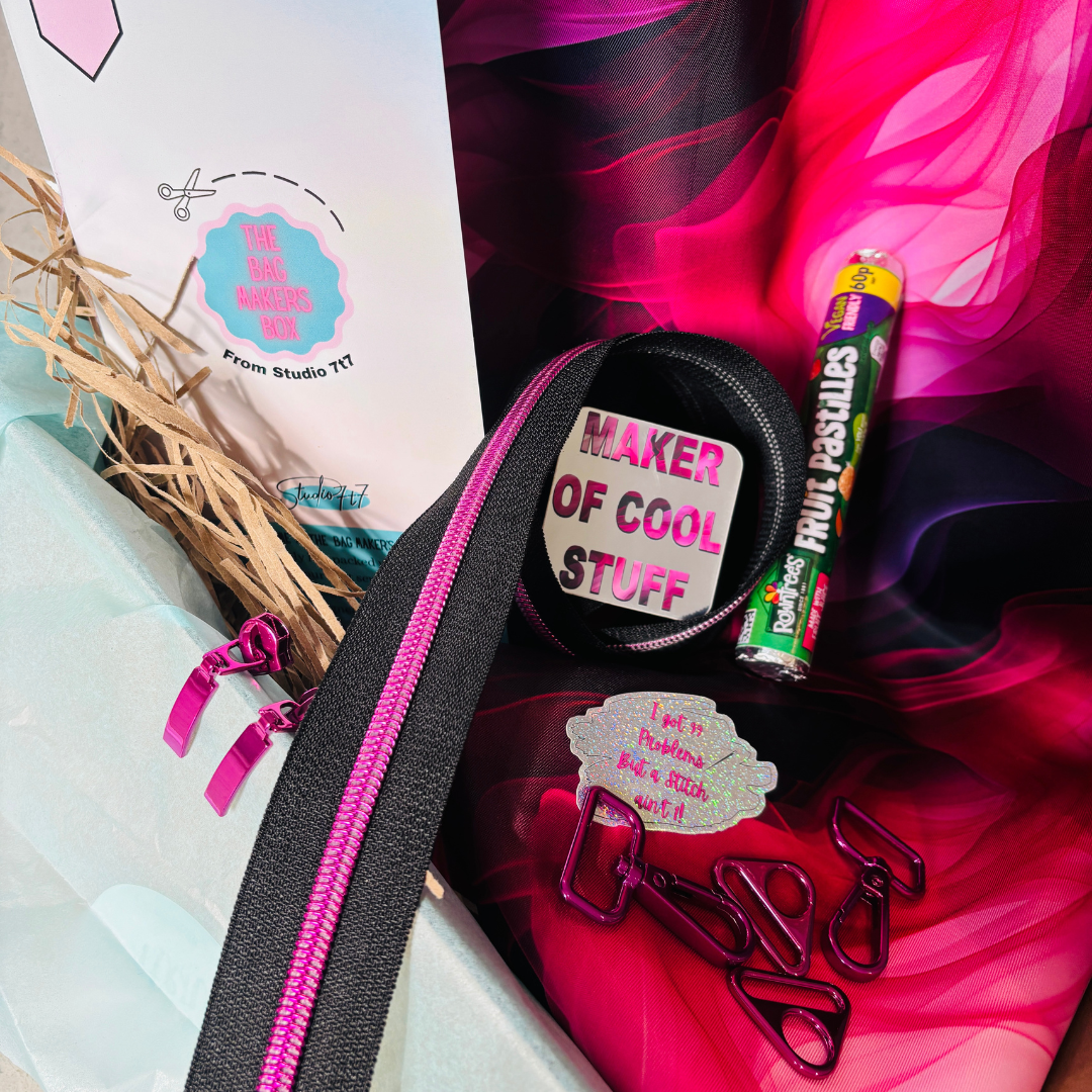 Bag Maker’s Box with bright pink and black fabric, zips, hardware, and “Maker of Cool Stuff” badge.