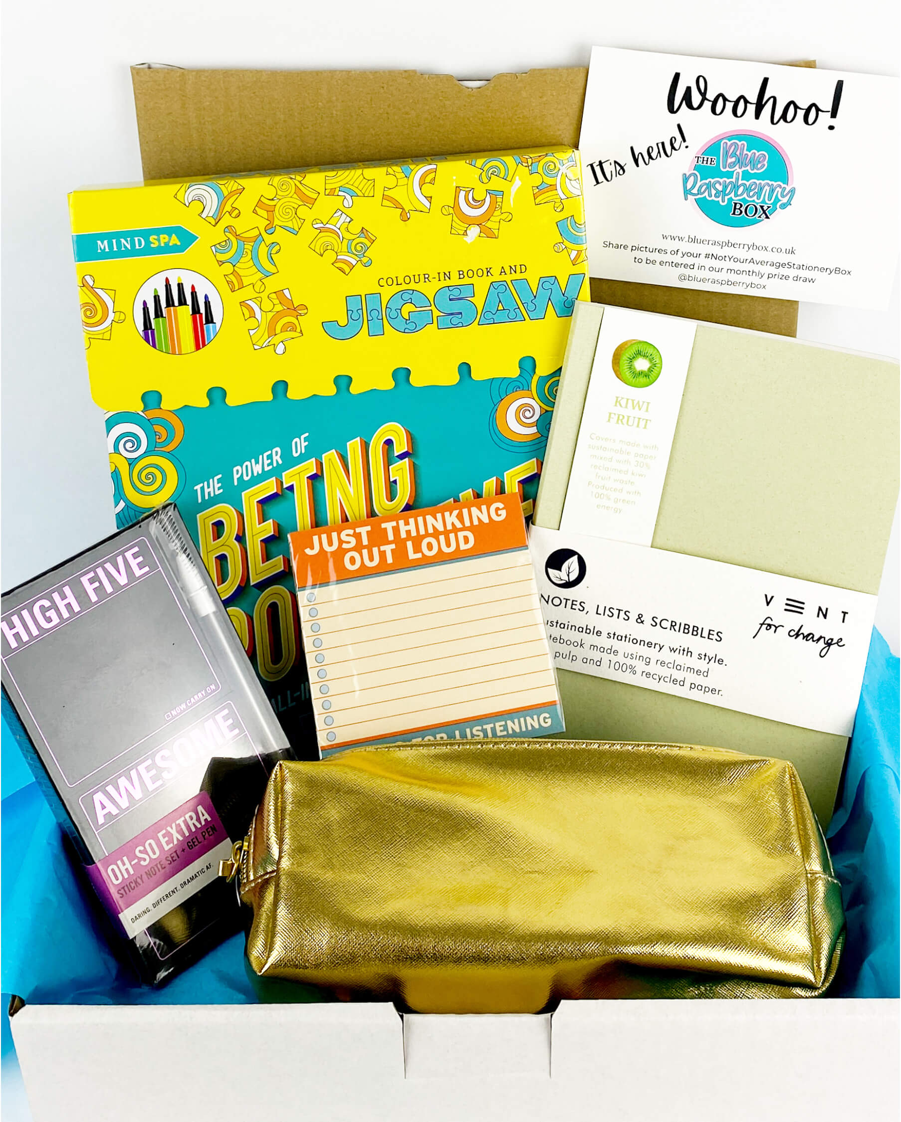 Gold pencil case with black post it notes and notebook with a mindful jigsaw puzzle in a white box