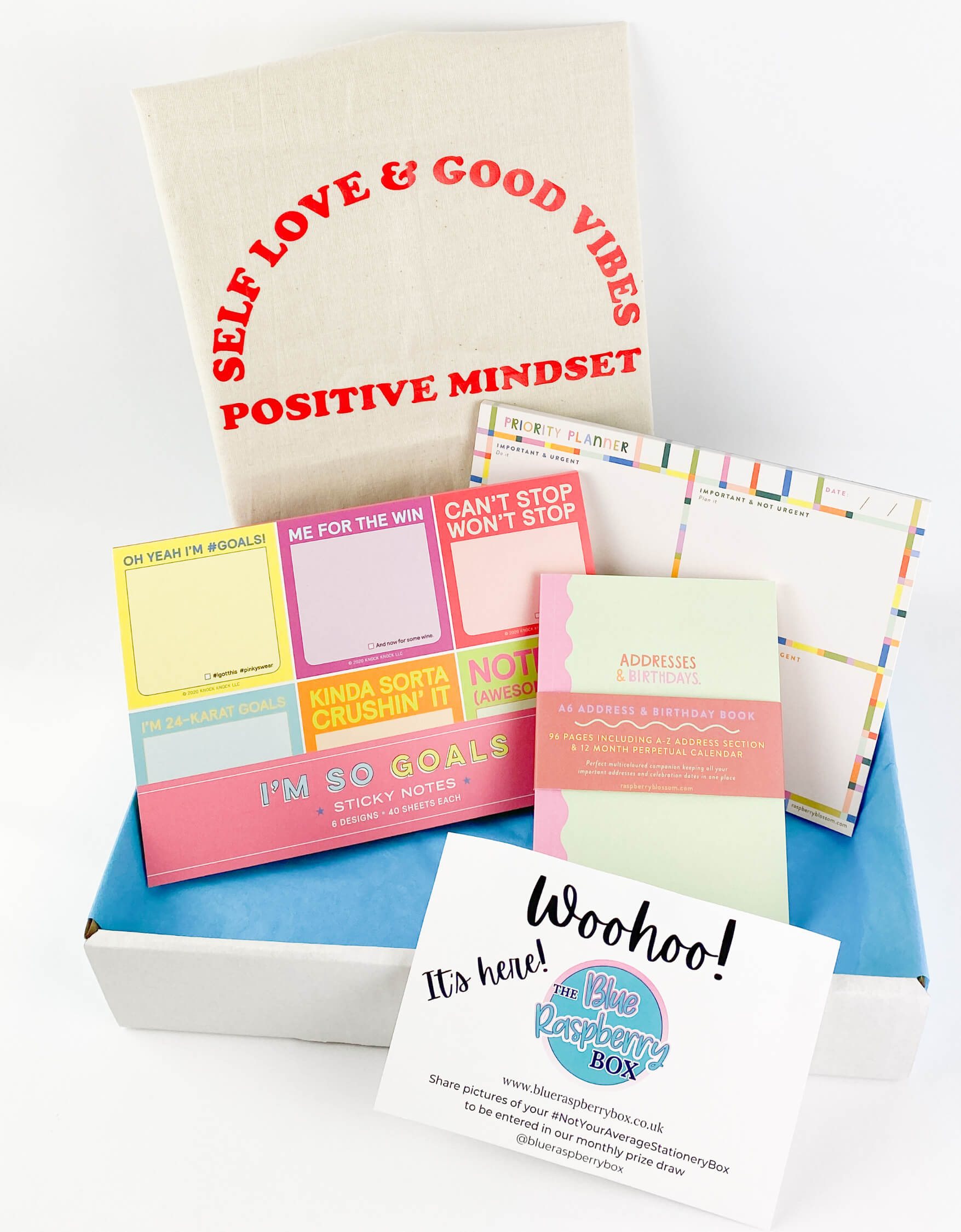 Bright and fun post it notes and planners with a canva bag behind with a positive affirmation