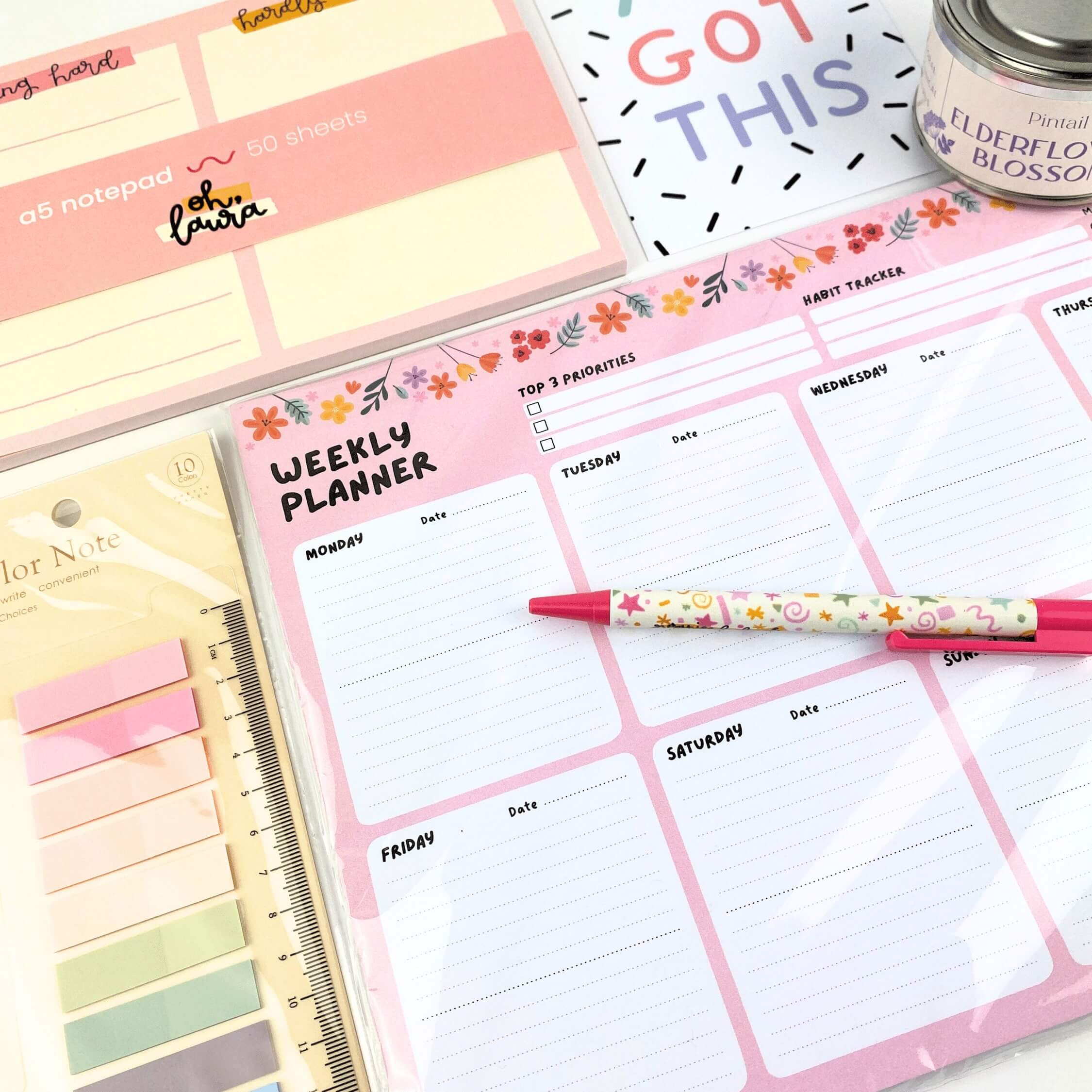 Pastel coloured desk planners, notepads and other stationery items