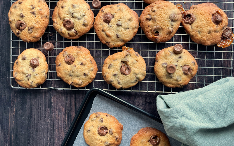 Rolo cookies on cooling rack with a tea towel