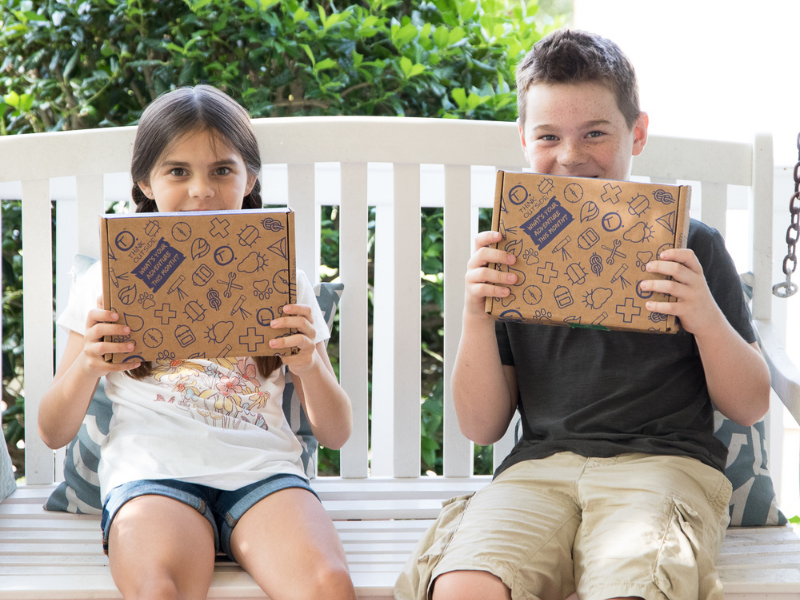 280-boy-and-girl-with-box-on-porch-17131338792122.png