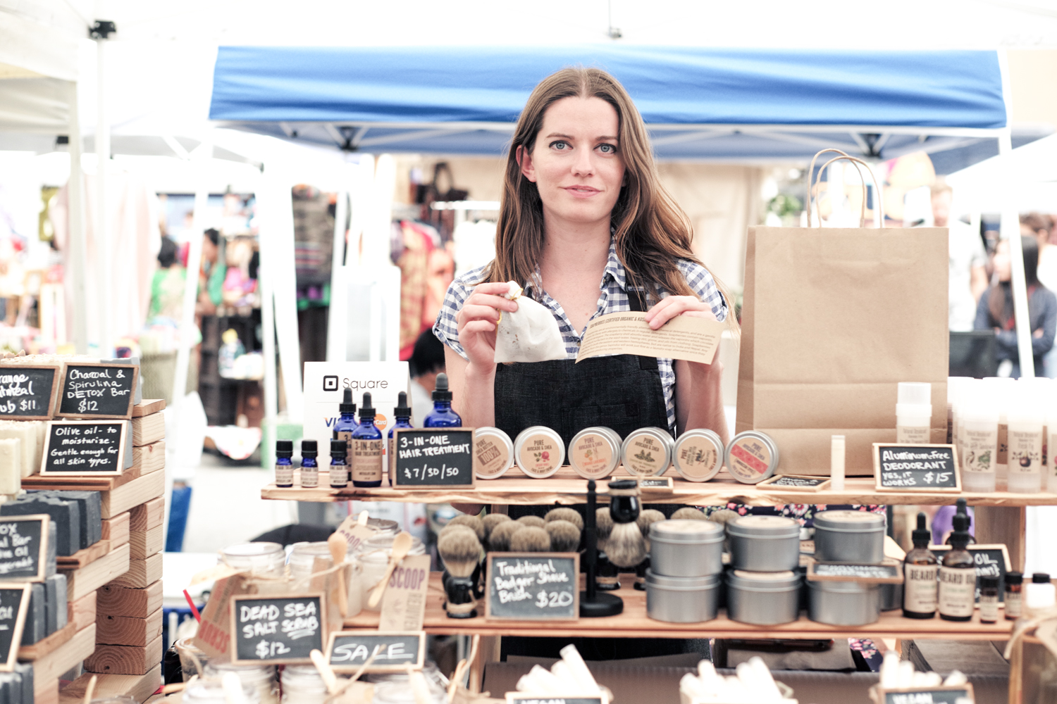 A photo of Callie selling homemade zero waste products at a farmers market